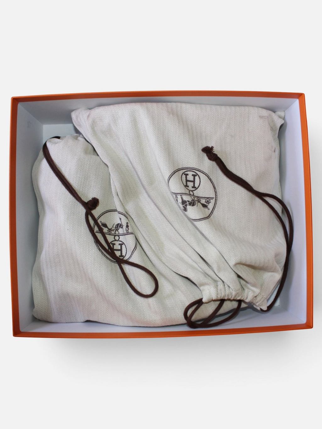 Fundas protectoras de tela beige con logo de Hibiscx's Archive para botines Hermès dentro de caja naranja